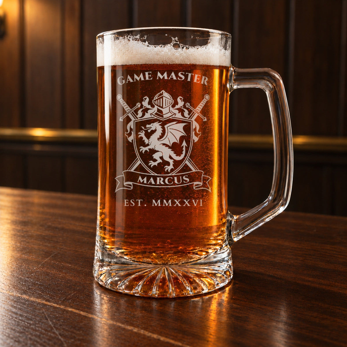 Geeky groomsmen gift: a personalized 25 oz glass beer mug on a walnut bar top, laser engraved with a dragon crest, GAME MASTER over the shield and MARCUS on the banner