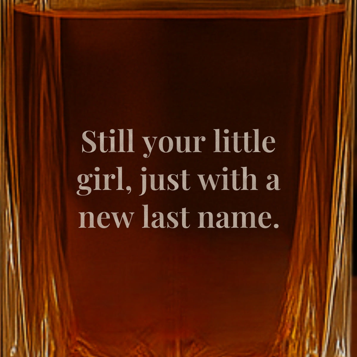Close-up of a note from the bride engraved on the back of a father of the bride decanter: Still your little girl, just with a new last name.