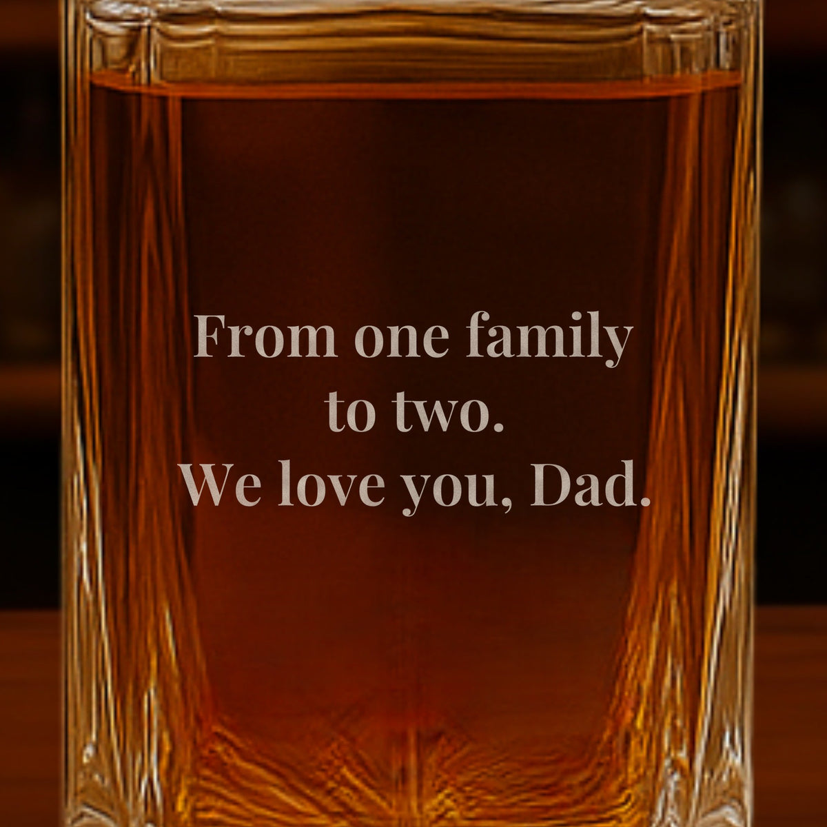 Close-up of a note from the couple engraved on the back of a father of the groom gift decanter: From one family to two. We love you, Dad.