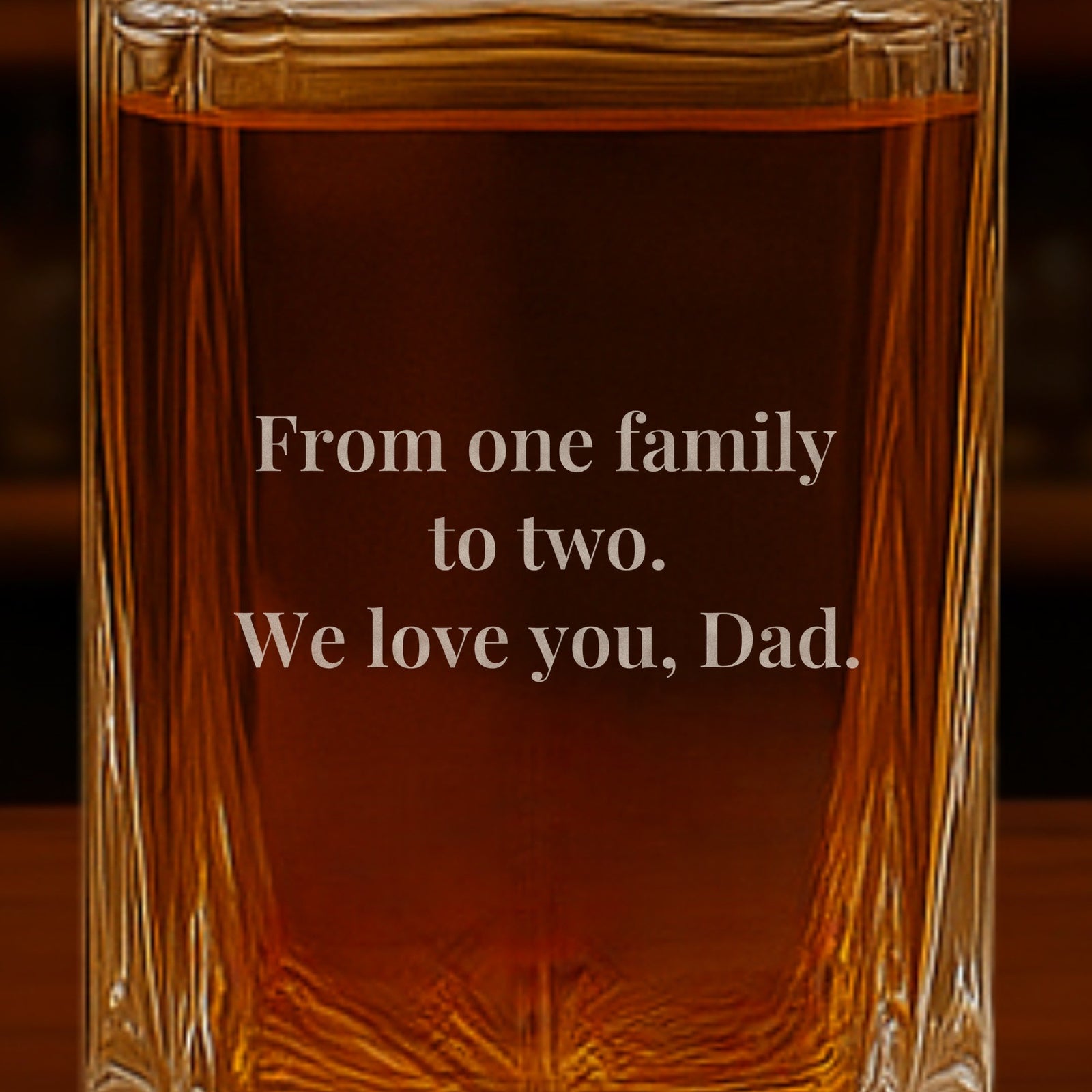 Close-up of a note from the couple engraved on the back of a father of the groom gift decanter: From one family to two. We love you, Dad.