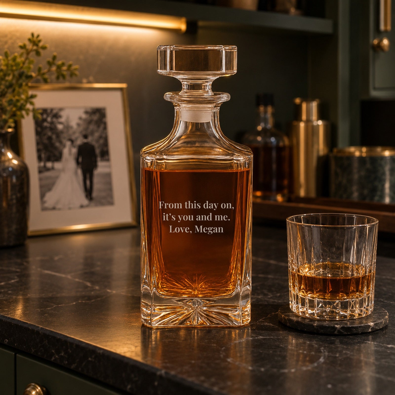 Wedding gift for husband on a home bar after the wedding, the decanter back engraved From this day on, it's you and me, Love, Megan, beside a rocks glass