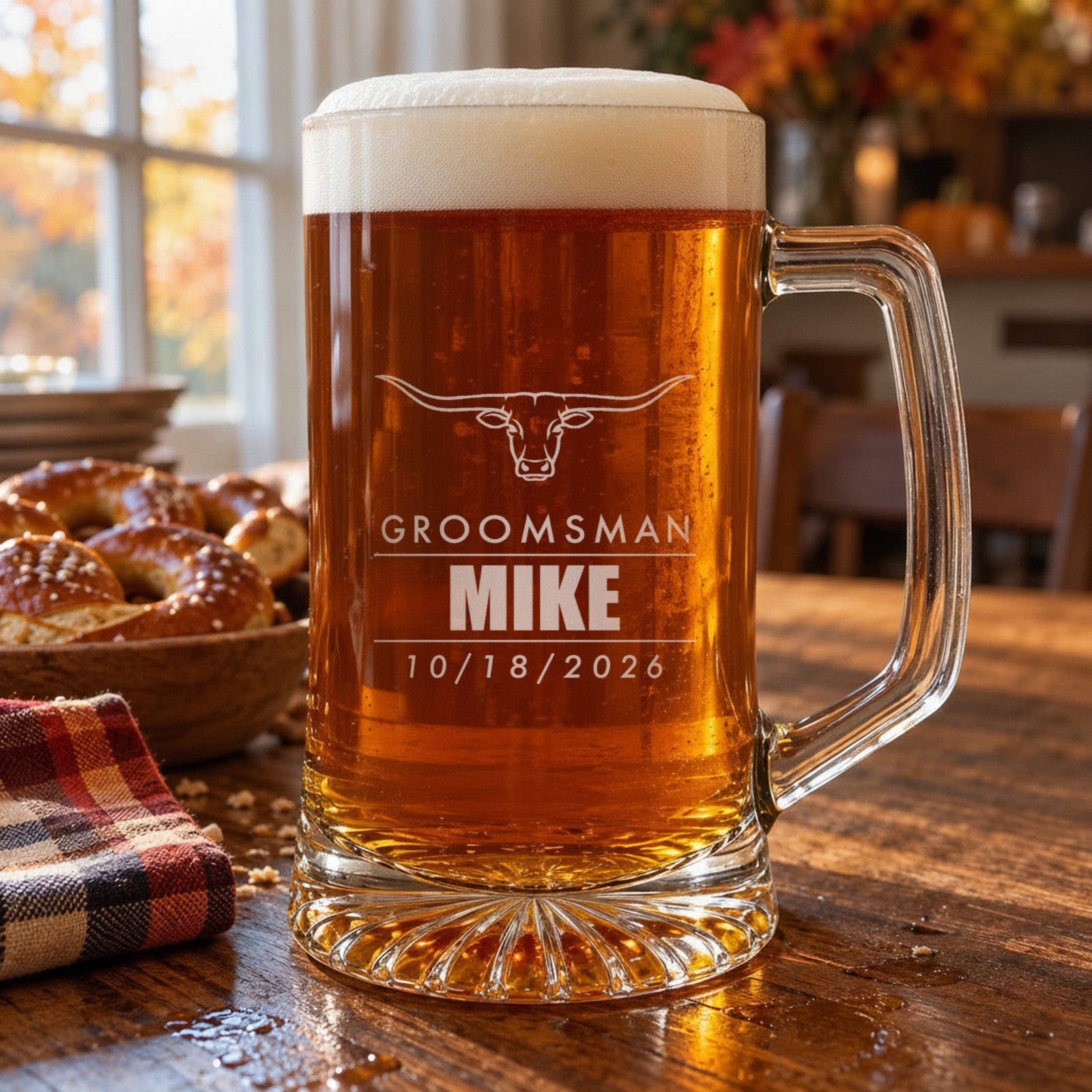 Engraved 25 oz groomsman beer stein on a wooden table, personalized with a longhorn, Groomsman, the name Mike and the wedding date 10/18/2026