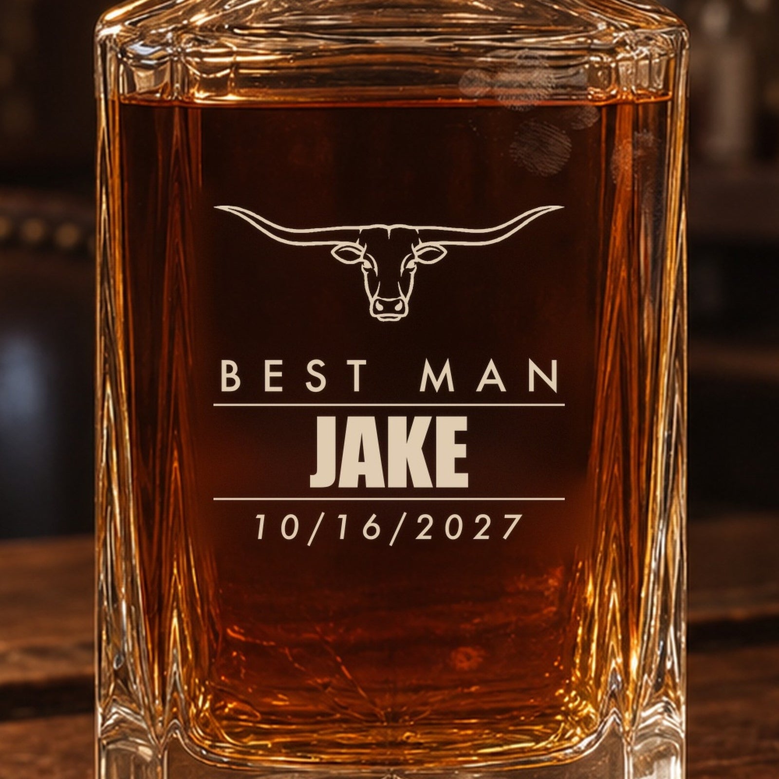 Close-up of the frosted laser engraving on the groomsmen whiskey decanter: a longhorn steer, Best Man, Jake in bold and the date 10/16/2027