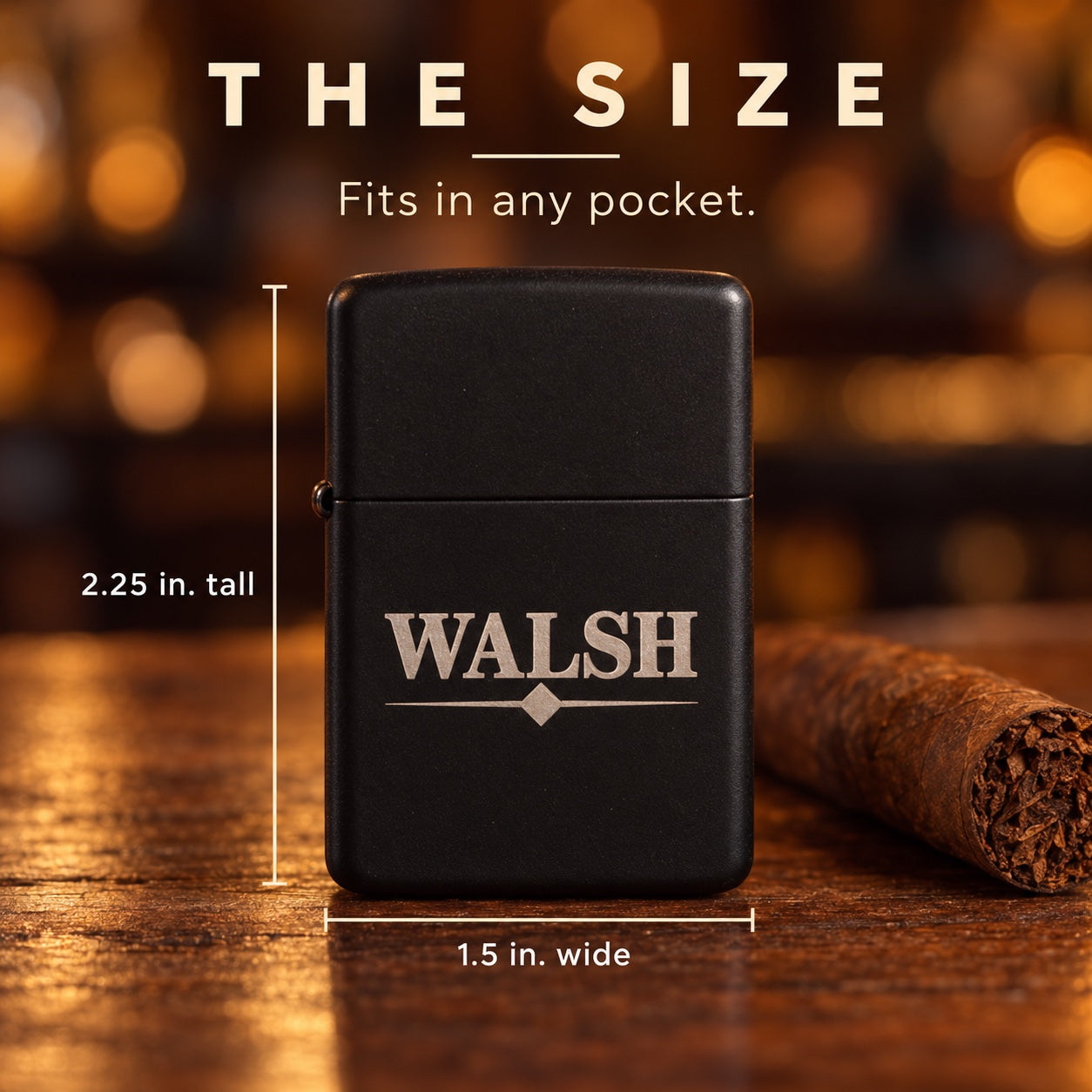 Size of the personalized groomsmen flip lighter: 1.5 inches wide and 2.25 inches tall, matte black engraved WALSH, shown beside a cigar for scale.