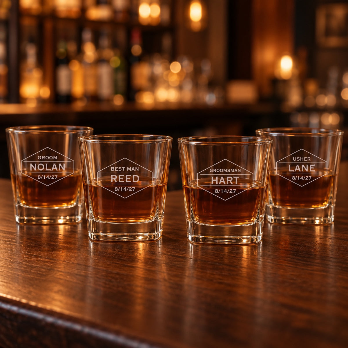 Four groomsmen whiskey glasses for the wedding party, engraved GROOM NOLAN, BEST MAN REED, GROOMSMAN HART and USHER LANE, each dated 8/14/27.