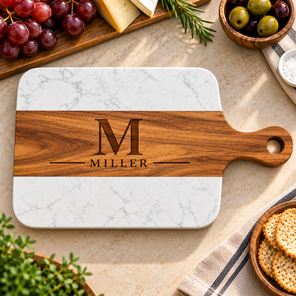 Heritage Monogram Wedding Board with an acacia band engraved with a large M and MILLER between white marble ends, a personalized charcuterie board for the couple