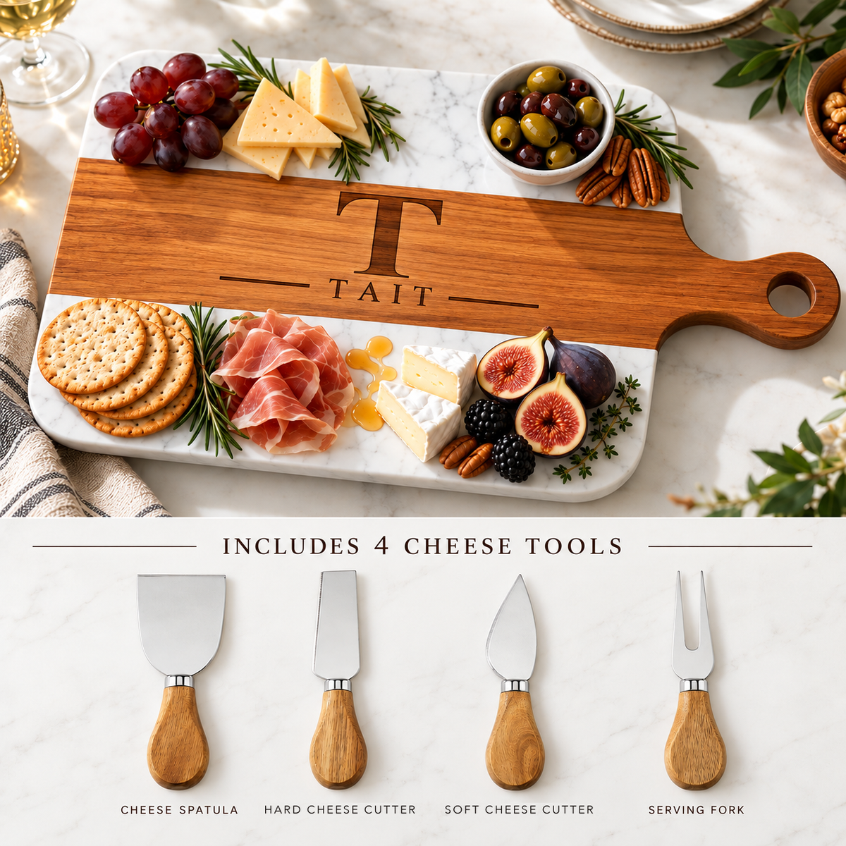 Personalized charcuterie board engraved with T and TAIT beside its four included wood-handled cheese tools, including a cheese spatula and a serving fork
