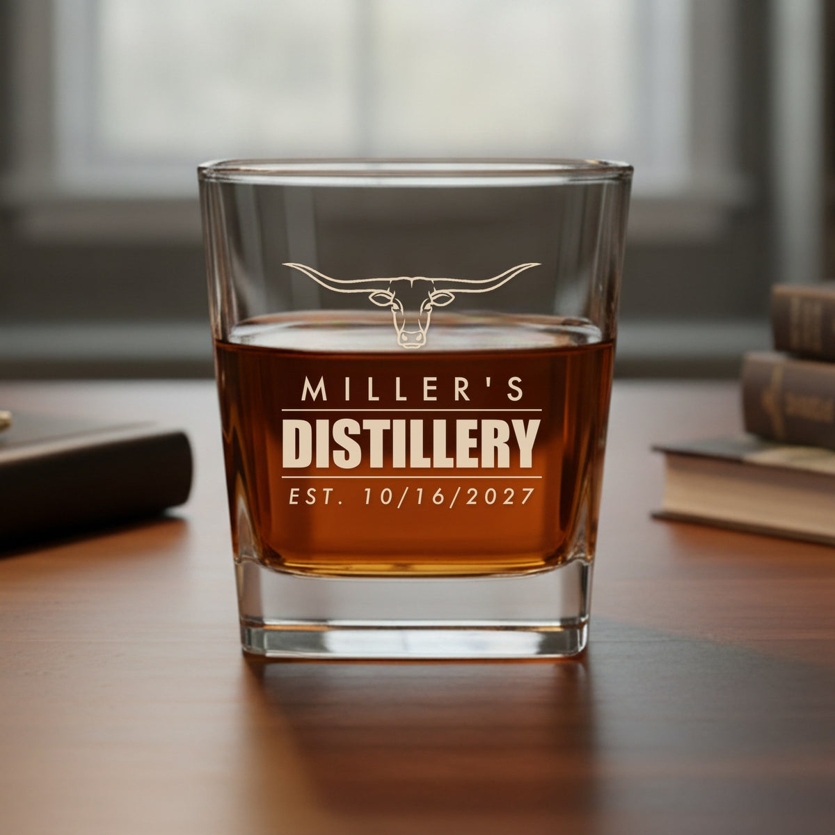 Engraved whiskey glass reading Miller's Distillery, Est. 10/16/2027 under a longhorn, a fun distillery label version of the groomsmen glass