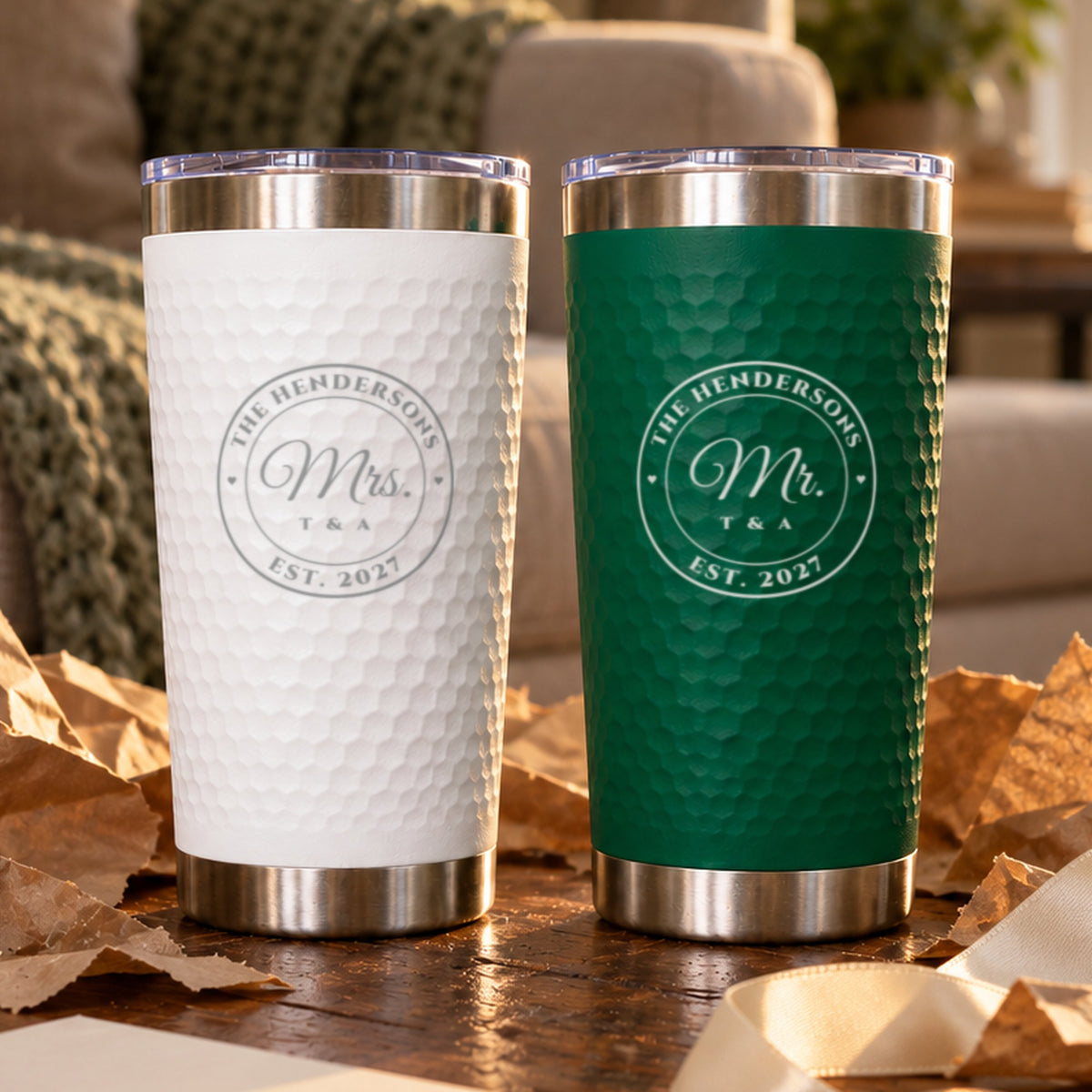 Green Mr. and white Mrs. tumblers engraved with a seal for The Hendersons, Est. 2027, on torn kraft paper, a wedding gift for the couple