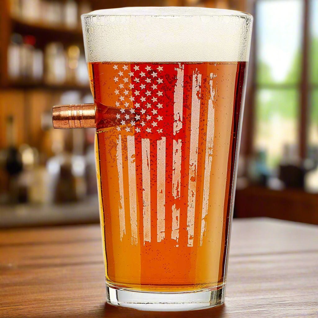 Pint glass with embedded .50 caliber bullet and etched American flag design