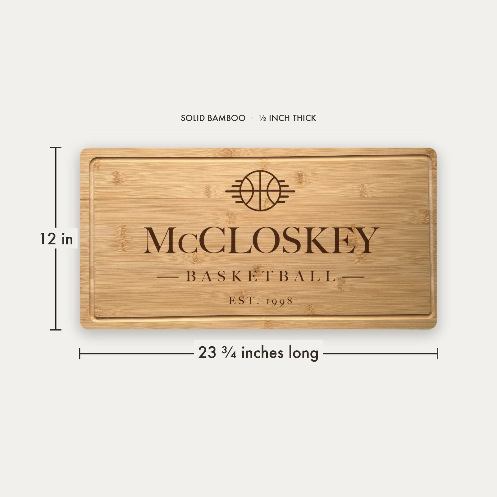 Size guide for the personalized basketball cutting board, 23 and three quarter inches long by 12 inches wide in half inch thick solid bamboo.