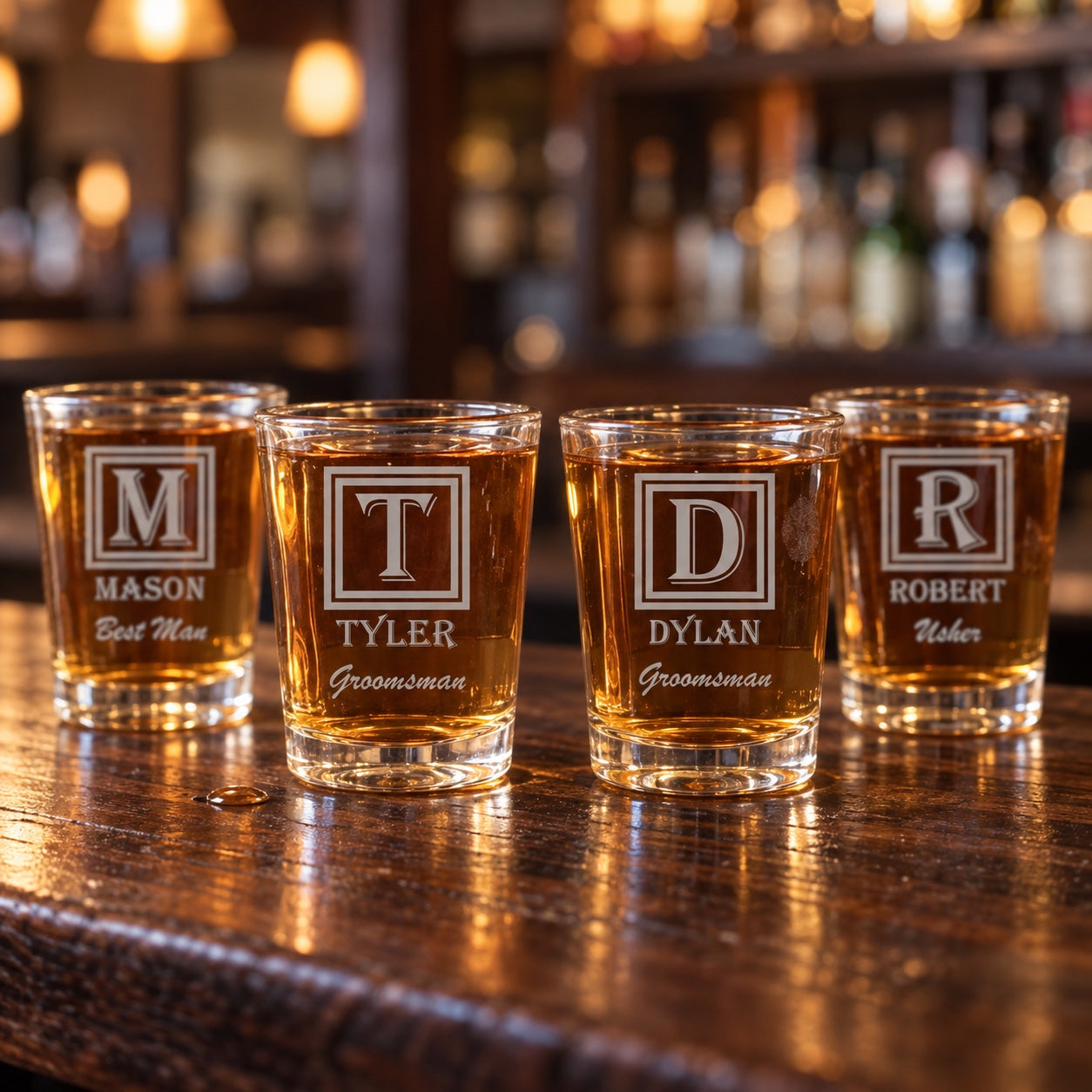 Four personalized groomsmen shot glasses with framed monograms for Mason the Best Man, Tyler and Dylan the Groomsmen and Robert the Usher