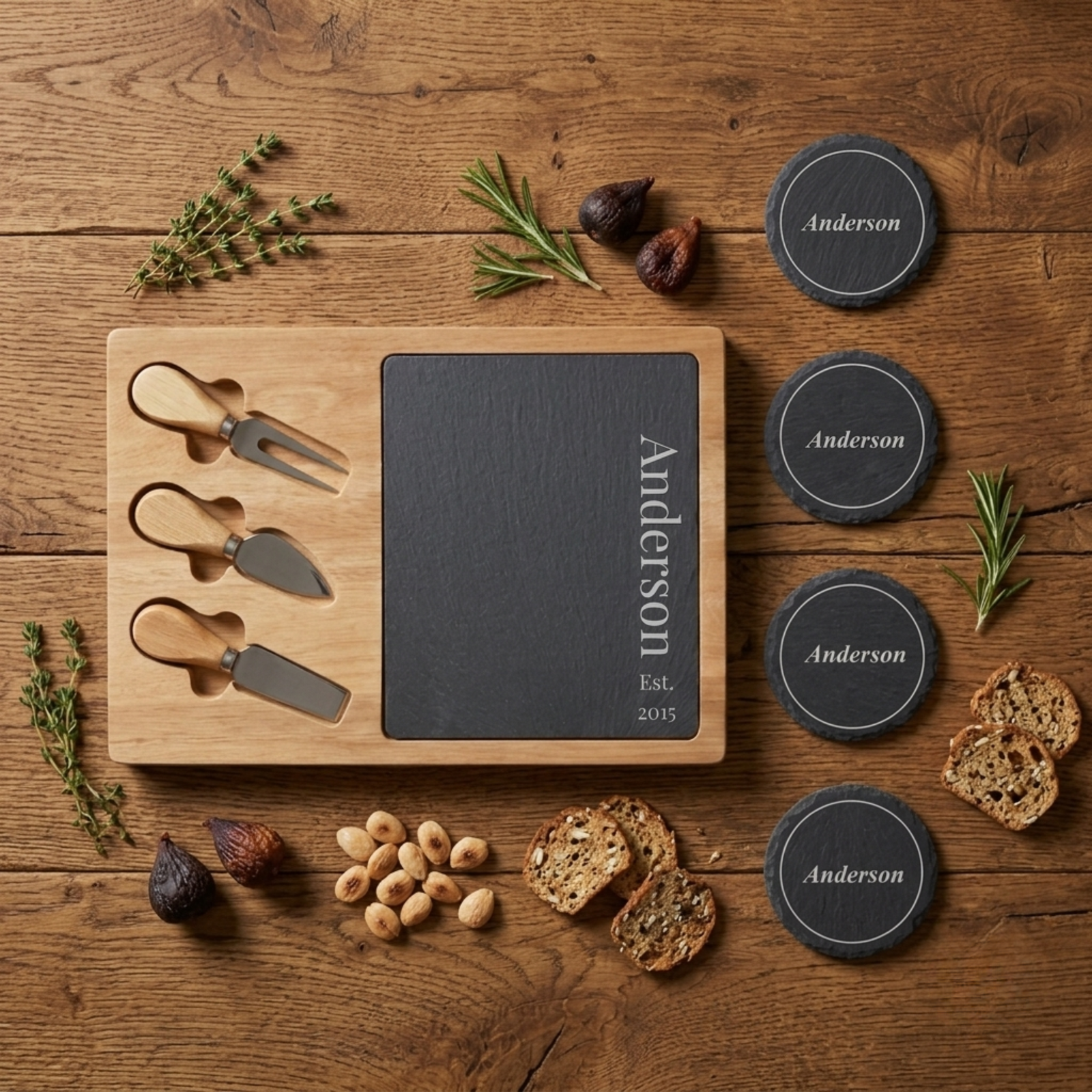 Engraved slate cheese board and coaster set personalized with a last name and Est. year, paired with three wood-handled cheese knives on an acacia board