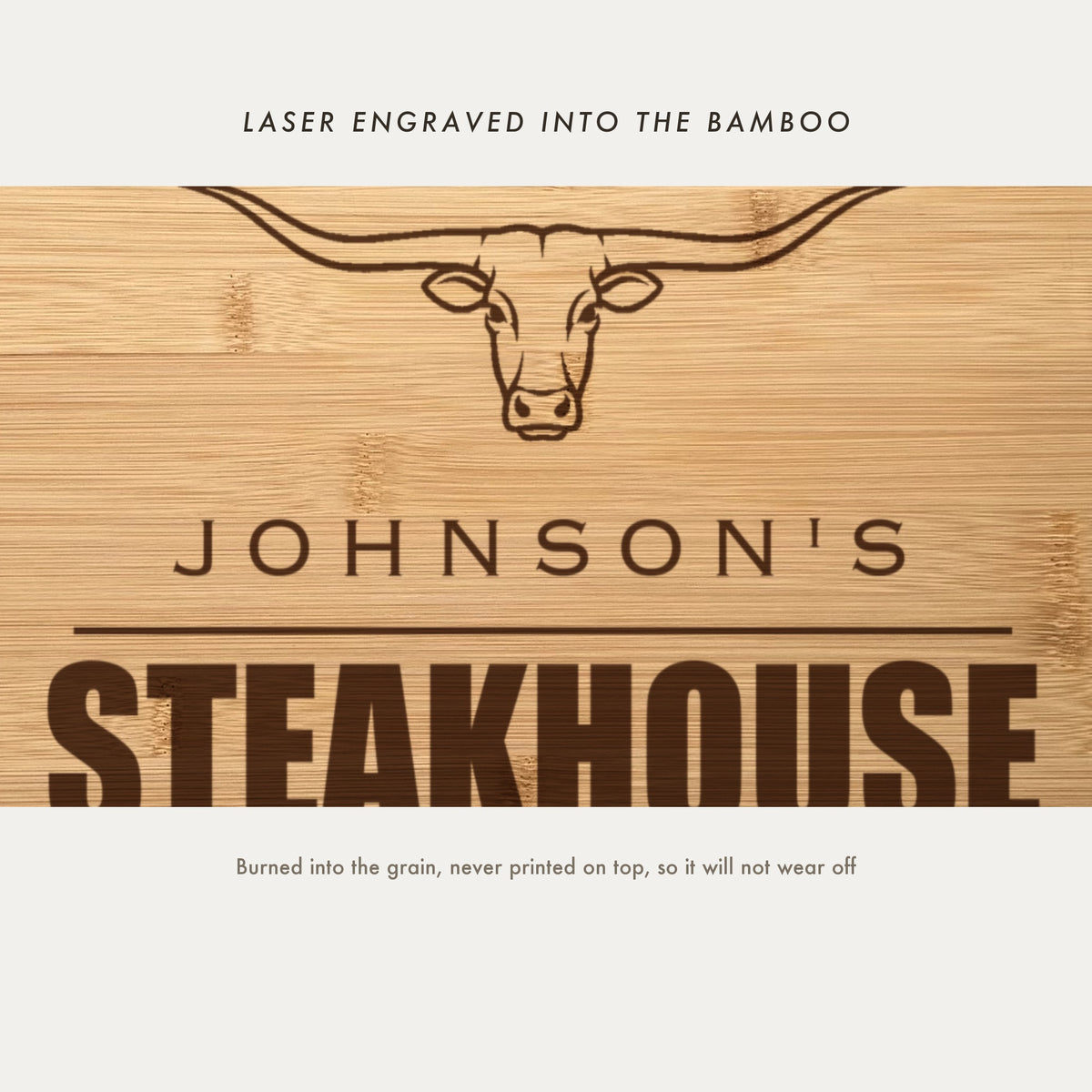 Close view of the longhorn steer and the word Steakhouse laser engraved into the bamboo grain in heavy block capitals between two rules.