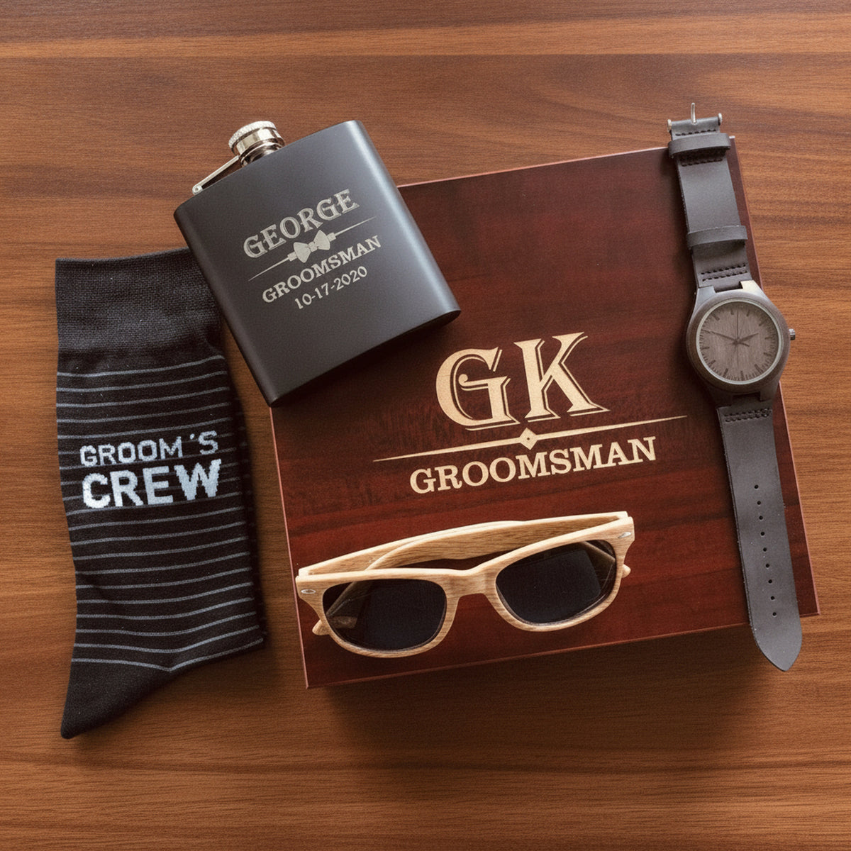 Personalized groomsmen gift set with engraved cherry keepsake box, matte black flask, Groom's Crew socks, wood grain sunglasses and sandalwood watch